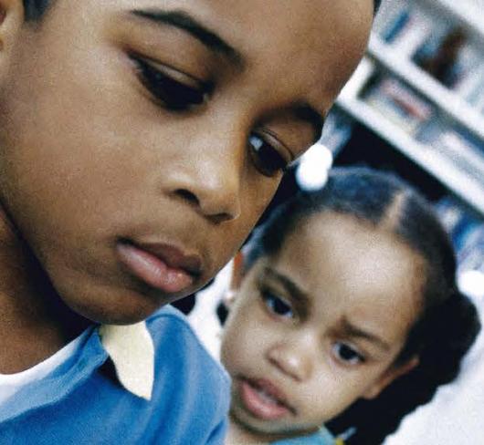 children in classroom looking at globe of world