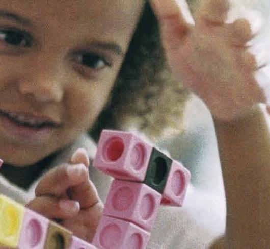 young girl playing with legos