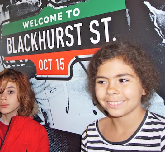 Kids standing in front of Blackhurst street sign