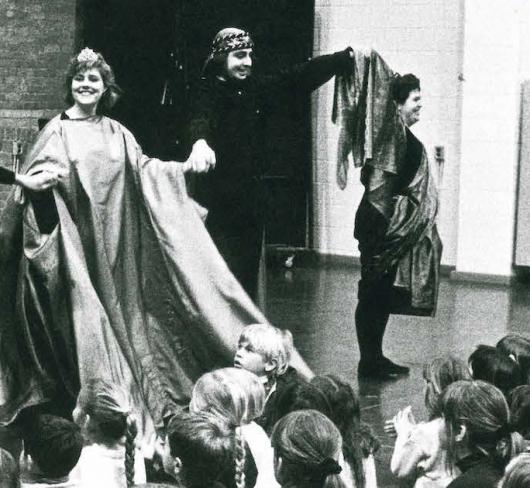 cast of play bowing in front of happy children