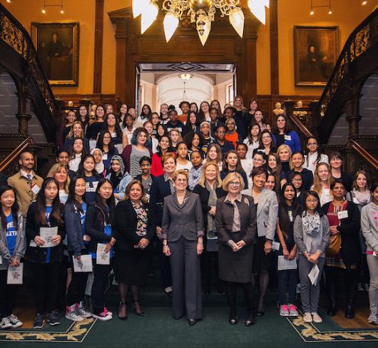 women and girls posing with political leaders