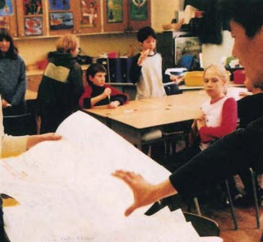 indigenous teacher in front of classroom