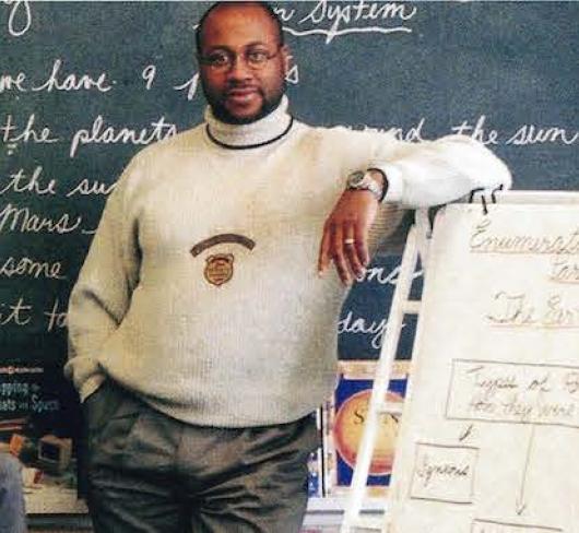 3 male teachers standing in classroom