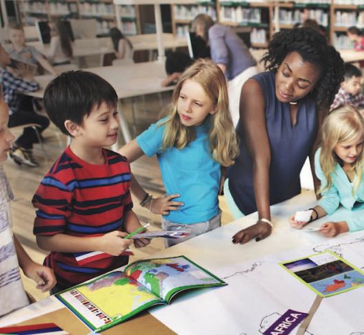 teacher with young children in classroom