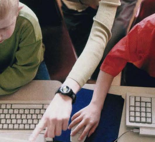 children using computers in classroom