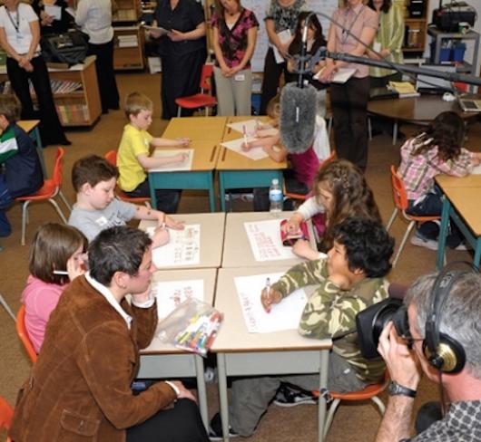 media filming teacher and students in classroom