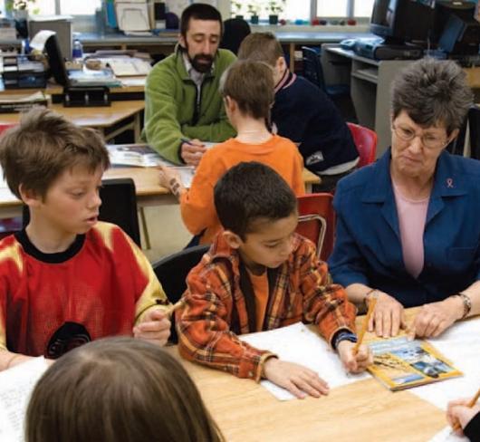 Teachers working with students in classroom