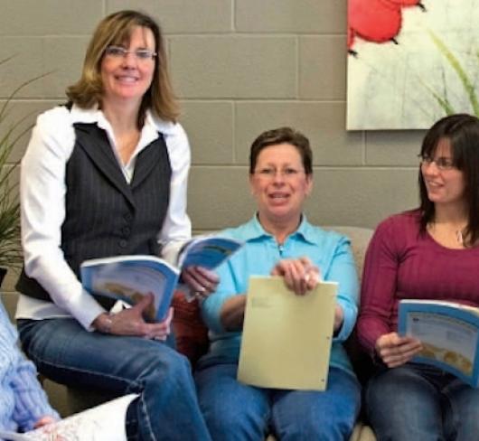 Teachers sitting together with books