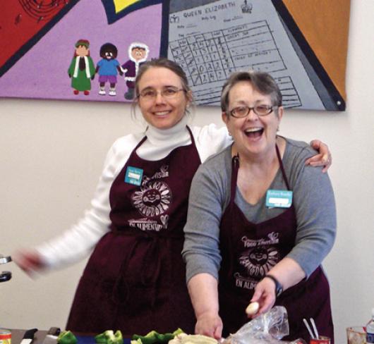 cooking teachers cooking together and smiling