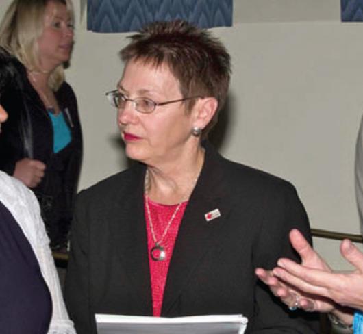 three women standing together having discussion