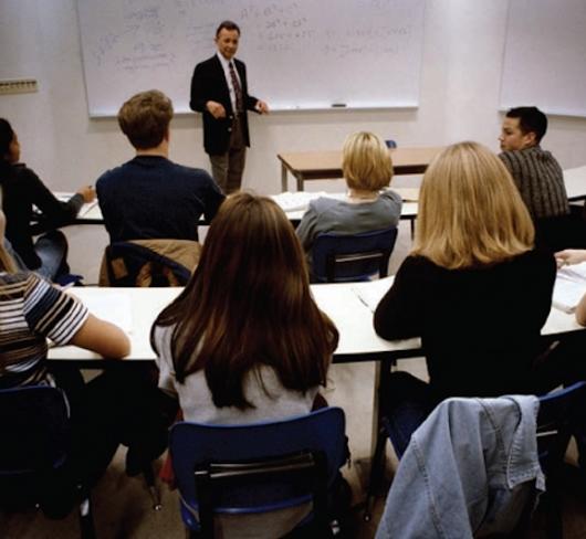 etfo members in classroom listening to man standing at whiteboard