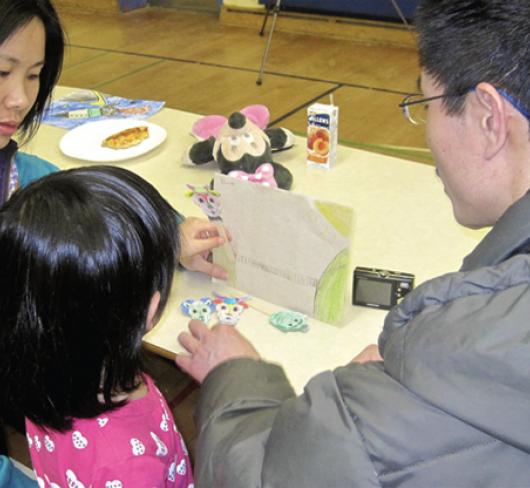 Parents with child looking at the child's work