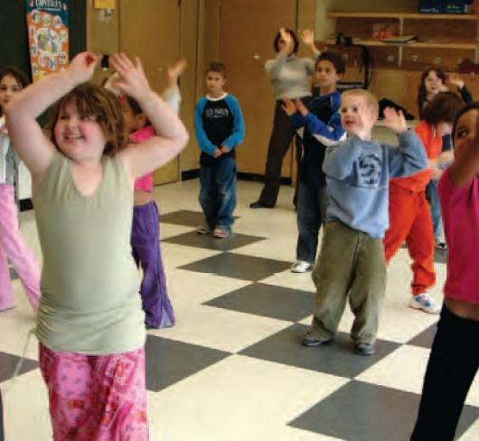 children dancing and playing in classroom