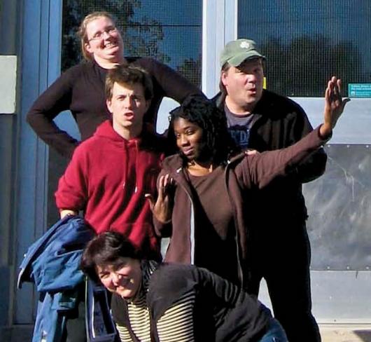 group of play actors posing outside of school