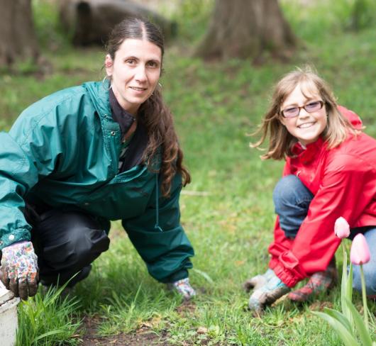 teacher and student working in garden