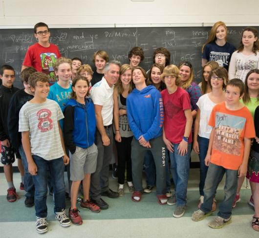 Group of elementary students standing together at front of classroom