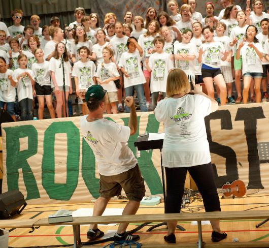 Motivational speakers hyping up crowd in gymnasium