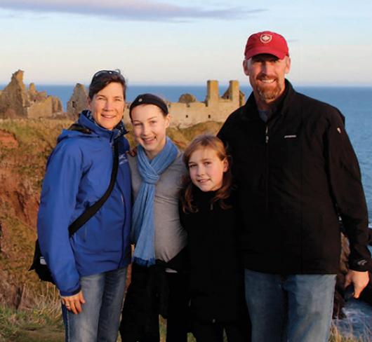 Michelle Richardson Family standing on cliff in Scotland