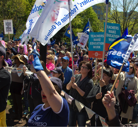 ETFO members standing with signs at rally